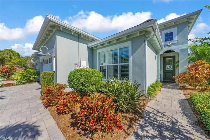 View of side of home featuring stucco siding and an attached garage