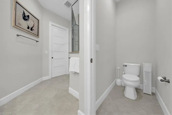 Master Bathroom featuring baseboards and toilet