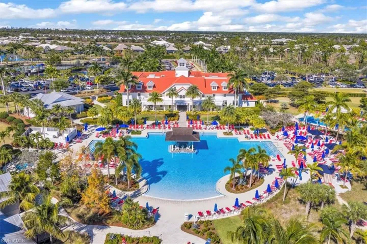 Drone / aerial view of a pool and a nearby body of water
