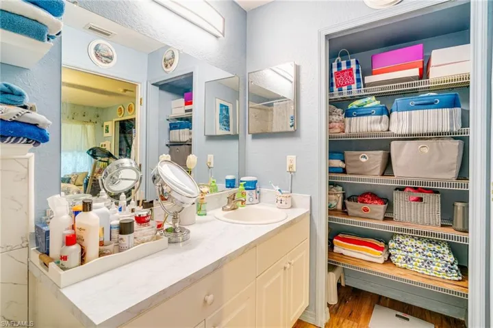 Bathroom with visible vents, wood finished floors, and vanity