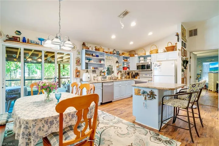 Kitchen featuring open shelves, light countertops, visible vents, and stainless steel appliances