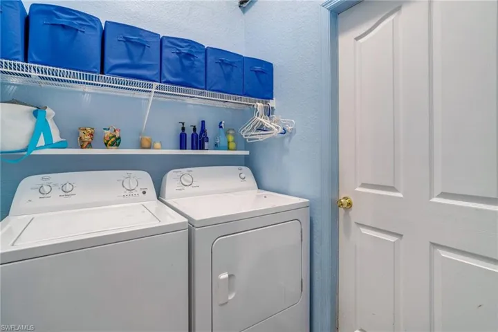 Clothes washing area featuring laundry area and independent washer and dryer