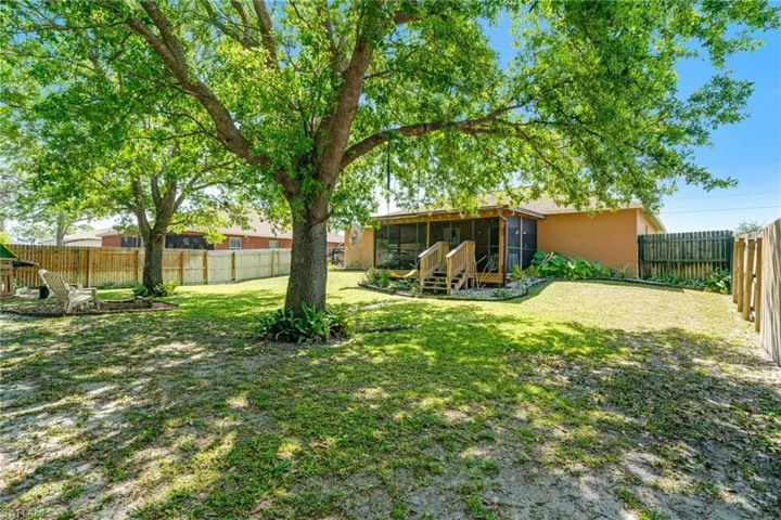 View of yard with a fenced backyard and a sunroom