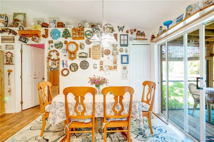 Dining space featuring lofted ceiling, an inviting chandelier, and light wood-style flooring