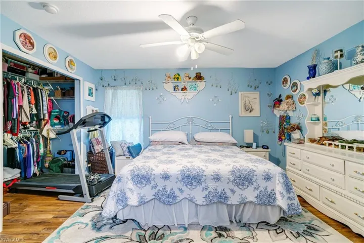 Bedroom with a closet, a ceiling fan, and wood finished floors