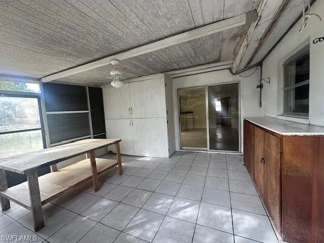 Screened lanai area with light tile patterned floors