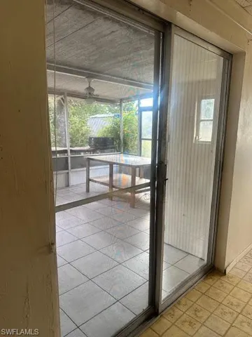 Doorway to outside featuring ceiling fan
