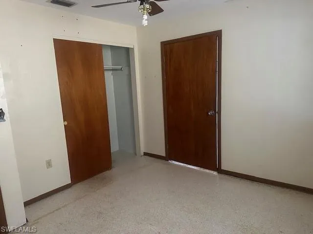 Guest Bedbedroom featuring terrazzo floors, a closet and ceiling fan