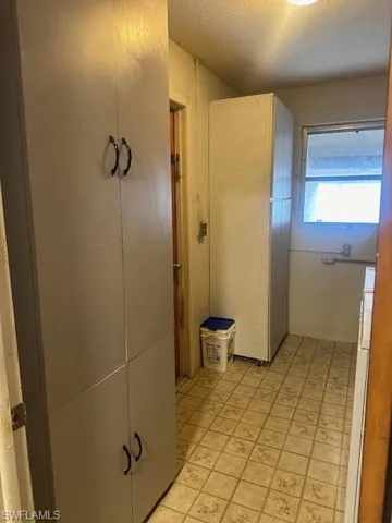 Laundry Room with a textured ceiling