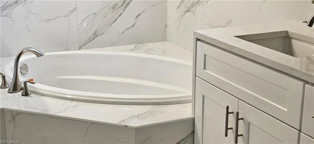 Bathroom with vanity and a tub