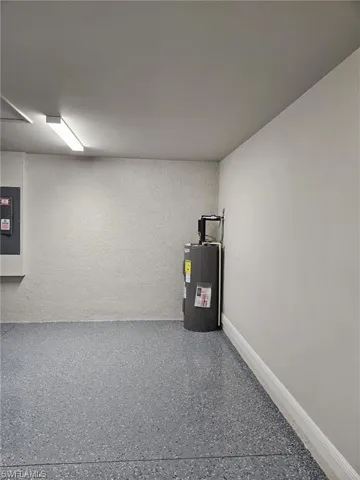 Utility room with electric panel and water heater