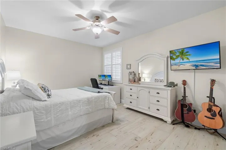 Bedroom with ceiling fan and light hardwood / wood-style flooring
