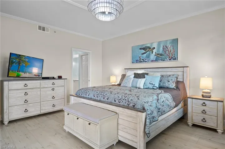 Bedroom featuring light hardwood / wood-style flooring and crown molding
