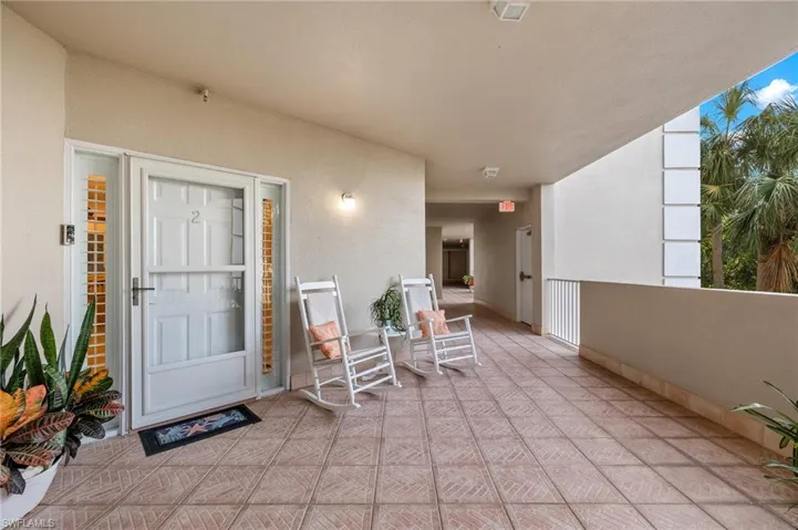 View of exterior entry with a patio