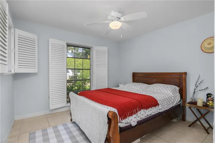 Bedroom featuring light tile patterned floors and ceiling fan