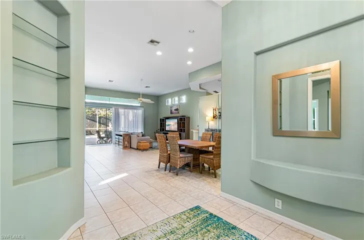 Corridor with accent niches and glass shelving.