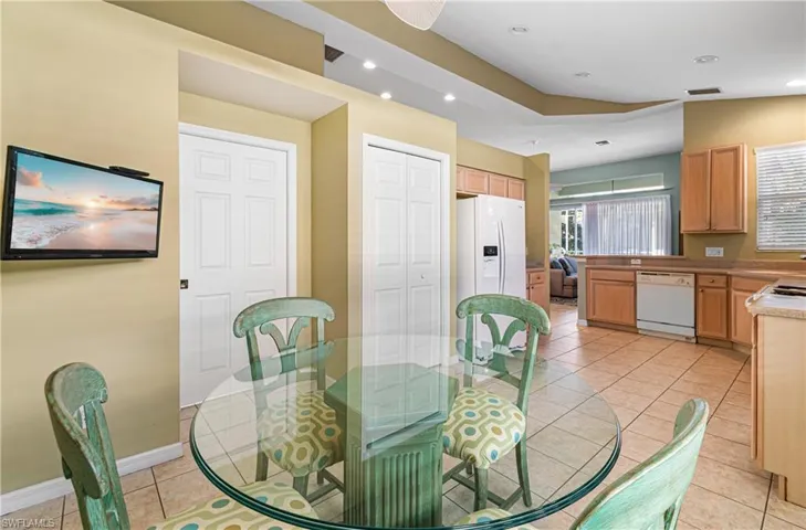 Dining area featuring light tile patterned flooring, recessed lighting, vaulted ceiling, and a ceiling fan
