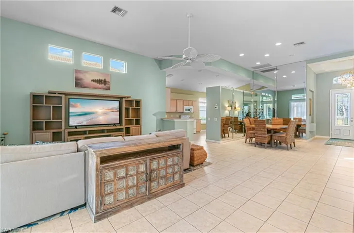 Living room featuring a ceiling fan, light tile patterned floors, and recessed lighting