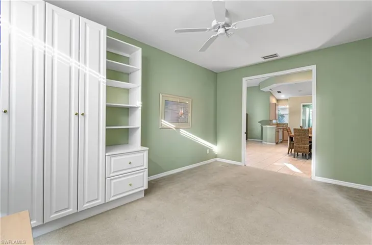 Den with double pocket doors and built in storage
