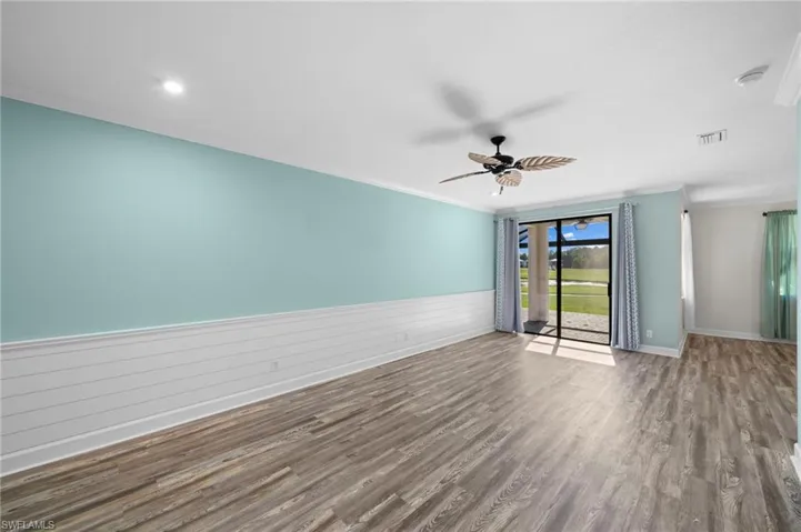 Unfurnished room featuring ornamental molding, wood-type flooring, and ceiling fan