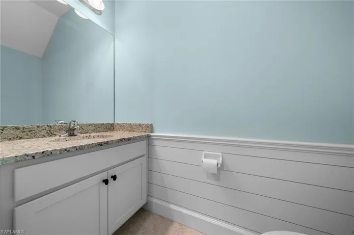 Bathroom featuring vanity and vaulted ceiling