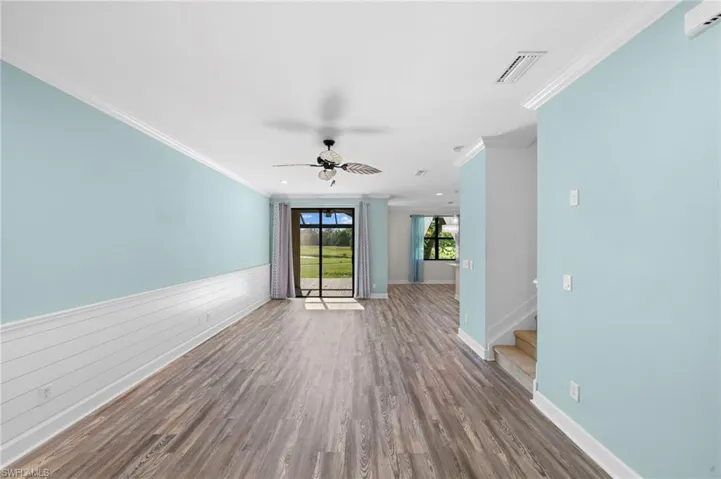 Unfurnished room with crown molding, hardwood / wood-style floors, and ceiling fan