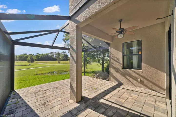 View of patio / terrace featuring a lanai and ceiling fan