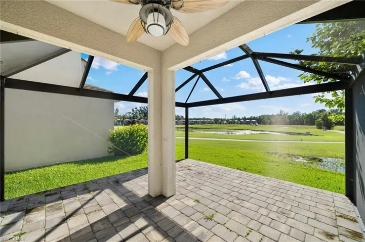 View of patio / terrace with a lanai, a water view, and ceiling fan
