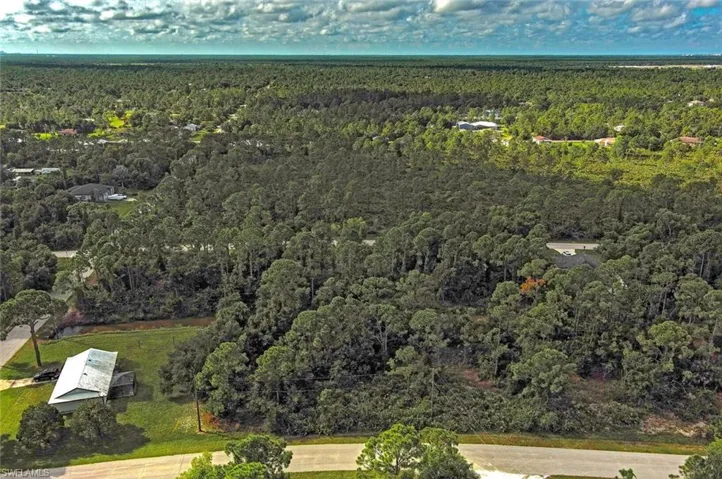 View of property location featuring a heavily wooded area