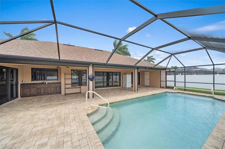View of swimming pool with a patio and a lanai