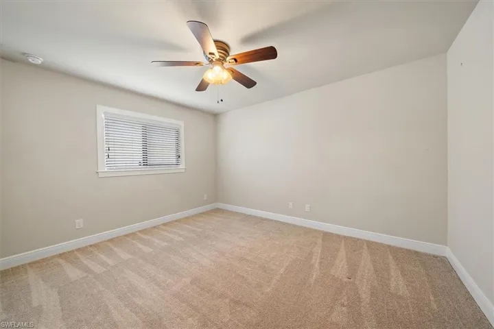 Carpeted bedroom 2 with ceiling fan