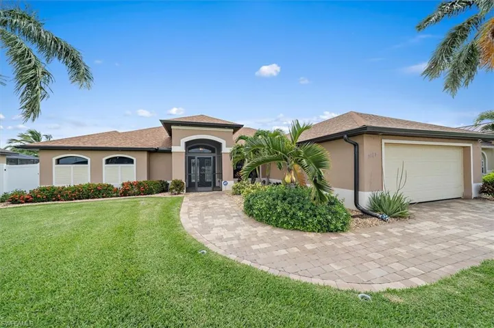 View of front of home featuring a garage and a front yard