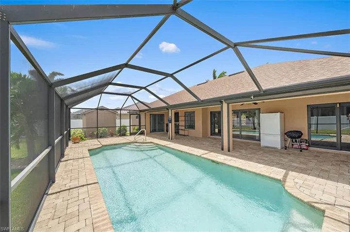 View of pool featuring a patio area and a lanai