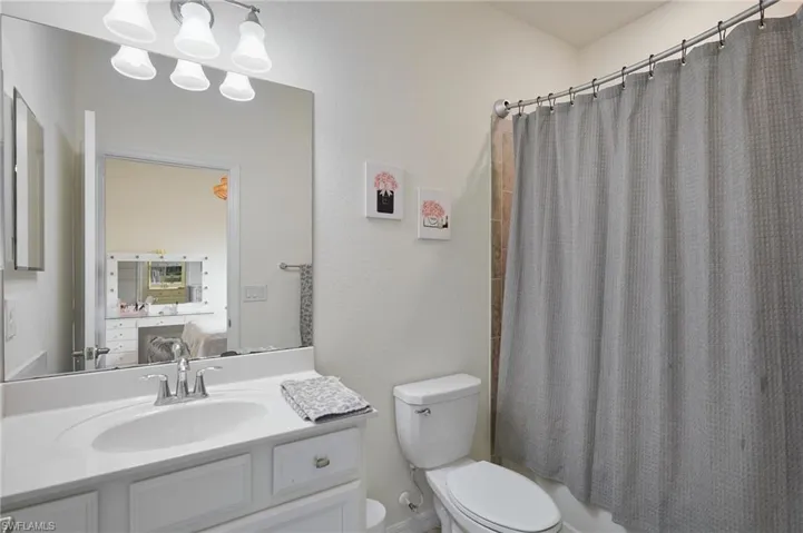 Full bath with shower / tub combo, toilet, and vanity