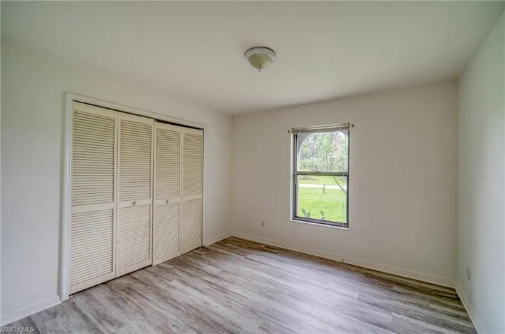 Unfurnished bedroom featuring light hardwood / wood-style floors and a closet