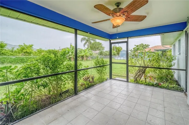 Unfurnished sunroom with ceiling fan