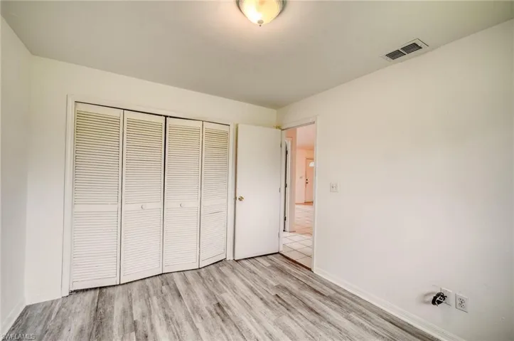 Unfurnished bedroom featuring a closet and light wood-type flooring