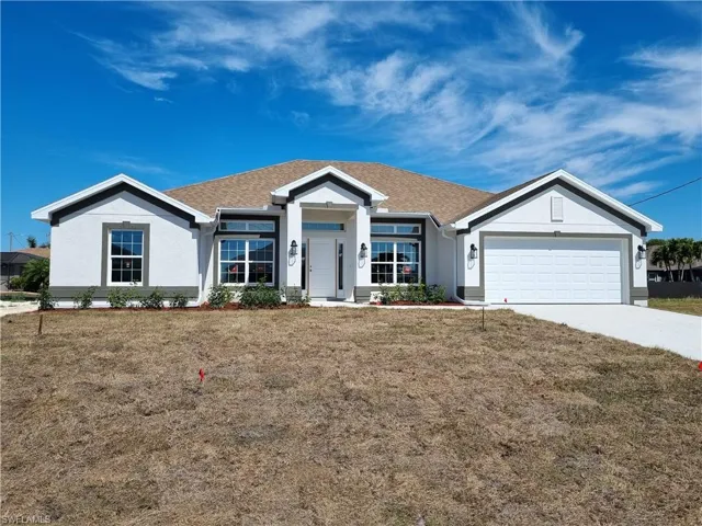 Ranch-style house featuring driveway, a front lawn, an attached garage, and a shingled roof