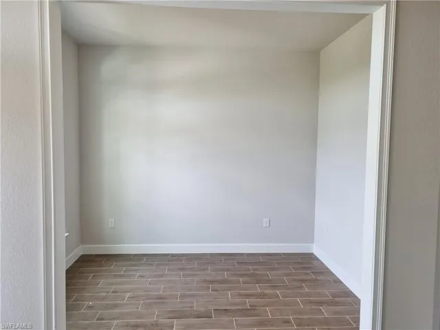 Spare room with wood tiled floors and baseboards