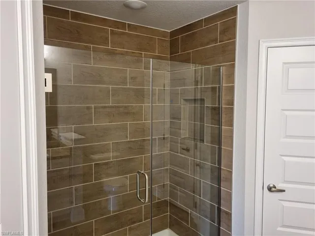 Full bathroom featuring a stall shower