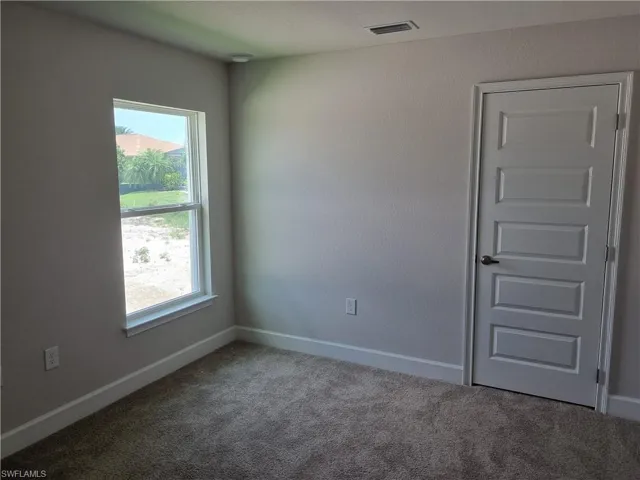 Unfurnished room featuring carpet flooring and baseboards