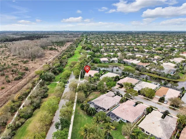 Aerial perspective of suburban area with a nearby body of water