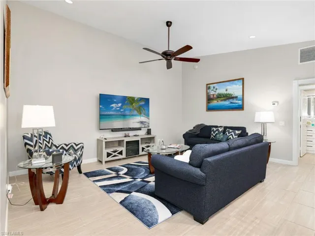 Living room featuring recessed lighting and a ceiling fan