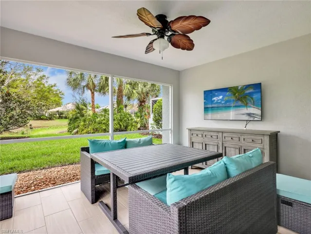 Sunroom featuring a ceiling fan and an outdoor living space