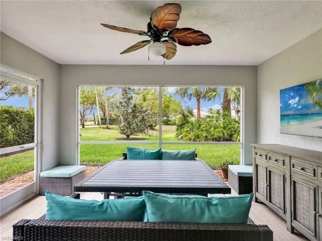 Sunroom with a ceiling fan and outdoor seating
