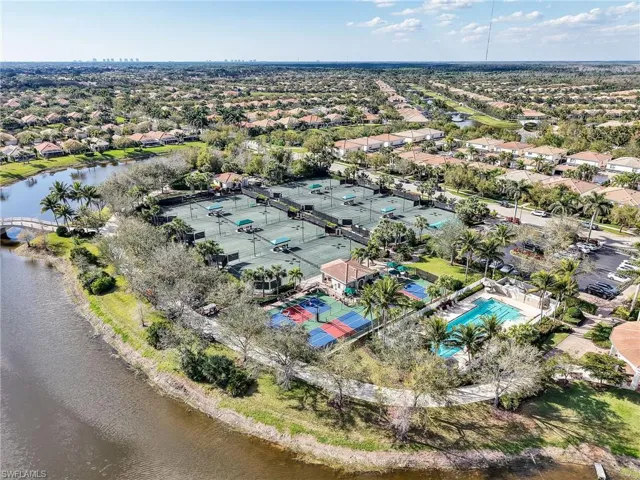 Aerial view of residential area featuring a nearby body of water