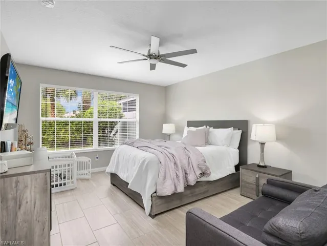Bedroom featuring a ceiling fan and a textured ceiling
