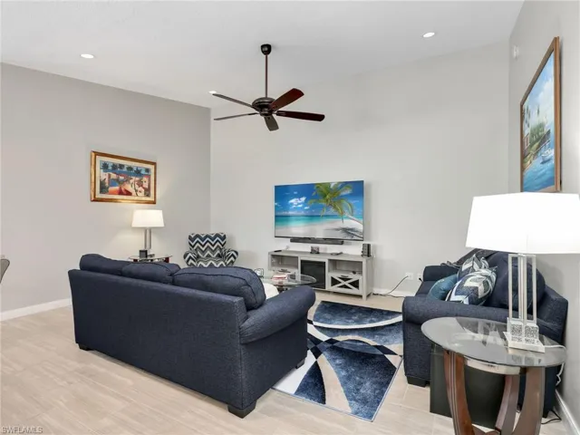 Living room featuring recessed lighting, ceiling fan, and light wood-type flooring