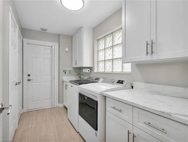 Laundry room with cabinet space and independent washer and dryer