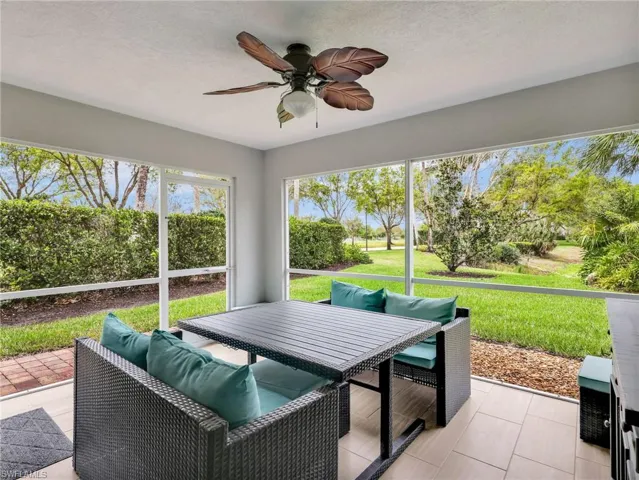 Sunroom featuring a ceiling fan, outdoor dining space, and plenty of natural light